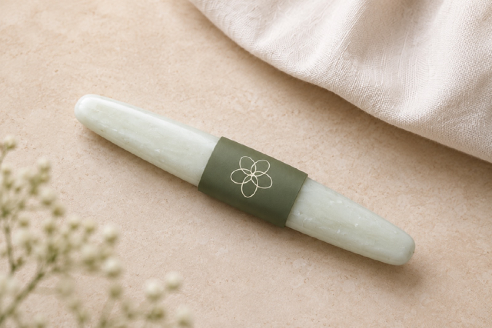 Close-up lifestyle photo of the Flor Femme wand on cream fabric